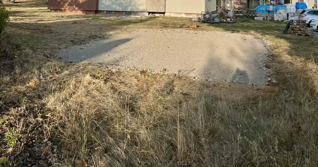 A compacted gravel pad gives a level, free-draining base for a storage container.